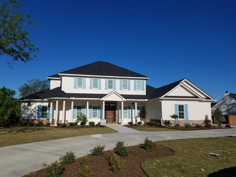 luxurious modern residential house with wide front landscape and driveway